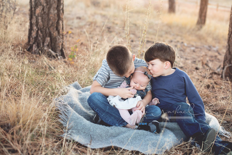Best family photographer in the Colorado areas of Denver, Aurora, Parker, Stapleton, Southlands, Centennial, Cherry Creek, Littleton, Highlands Ranch, Morrison, Brighton, Lone Tree and Castle Rock taking photos of children, sisters, brothers, moms, dads, toddlers in trees and woods.