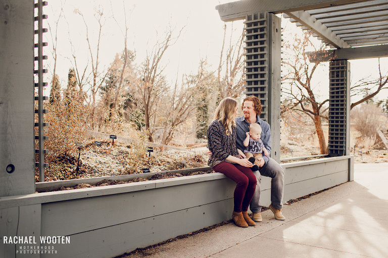 Denver family with mom dad and baby boy at Denver Botanic Gardens for a family photo shoot and wearing a Wildbird ring sling