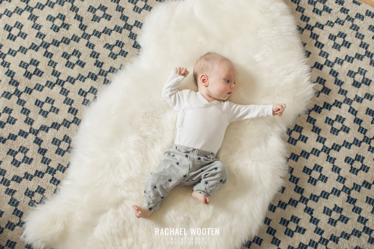 Lifestyle newborn photography session in the home with a mom, dad, and two month old baby in Denver, Colorado.